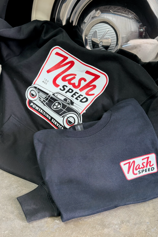 Two sweatshirts with 'Nash Speed' logo resting on a car tire
